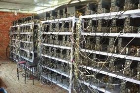 A view of a large-scale Bitcoin mining farm in Brazil, showcasing the rows of mining rigs and the cooling infrastructure.